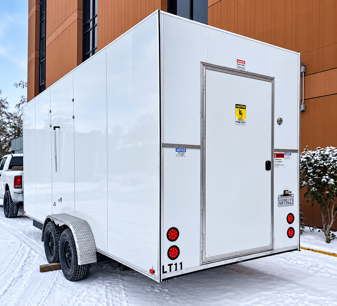 Rear and side of a white enclosed trailer