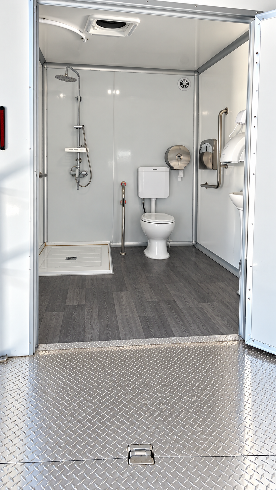 Shower and toilet fixtures inside a mobile combination trailer