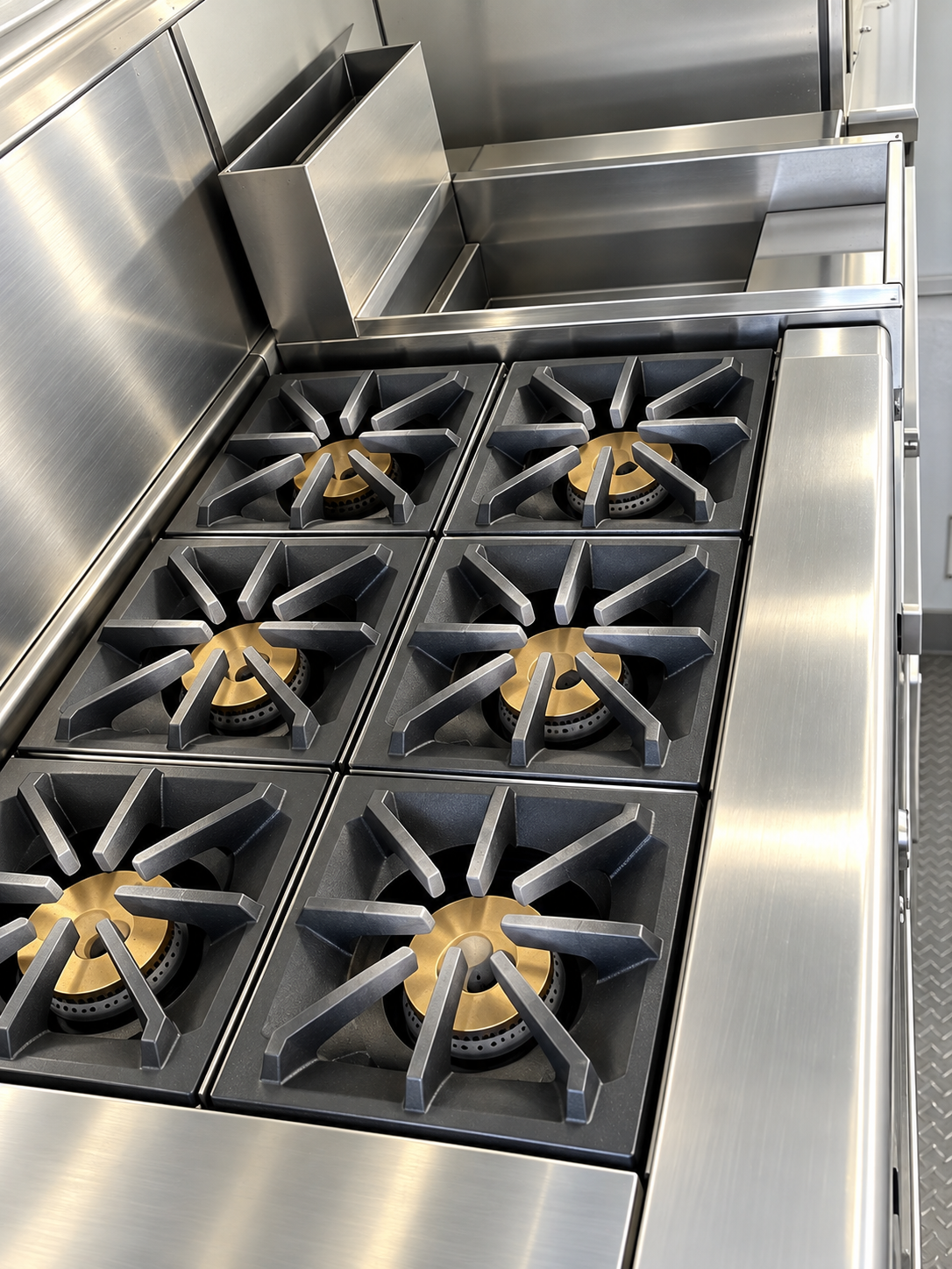 Six-burner commercial cooking range inside a mobile kitchen