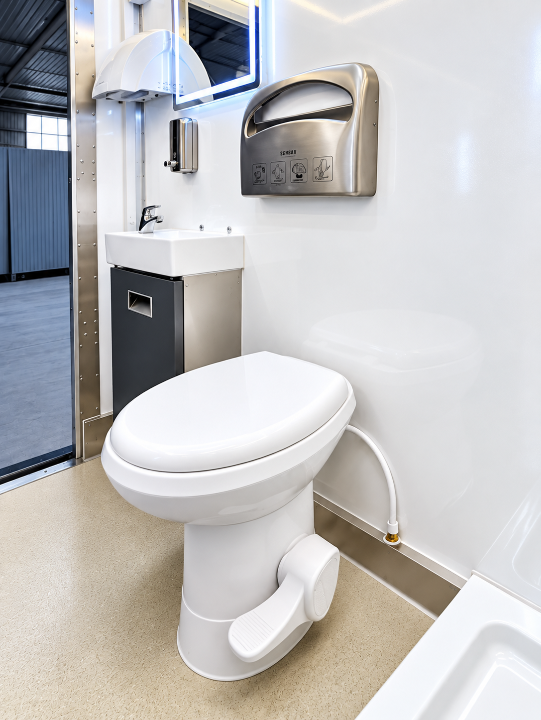 Toilet and sink inside a mobile restroom